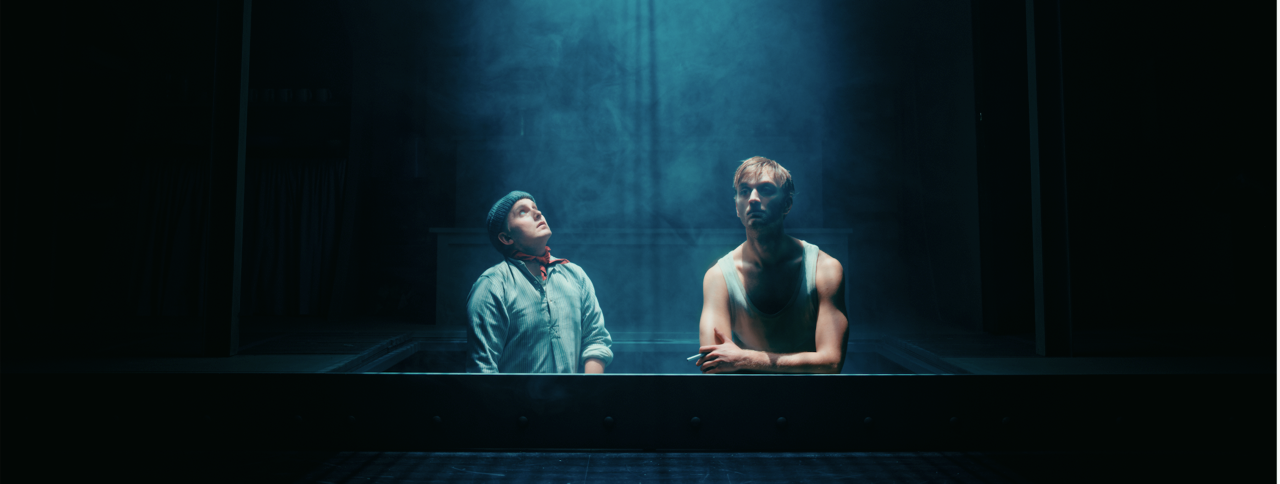 Patrick A. Hansen and Adam Schmidt in Den blinde passager at Aalborg Teater. Adam Schmidt uses a stage cigarette from Stage Props. Patrick A. Hansen and Adam Schmidt in Aalborg Teater’s production of Den blinde passager, with Adam Schmidt holding a Stage Props stage cigarette.